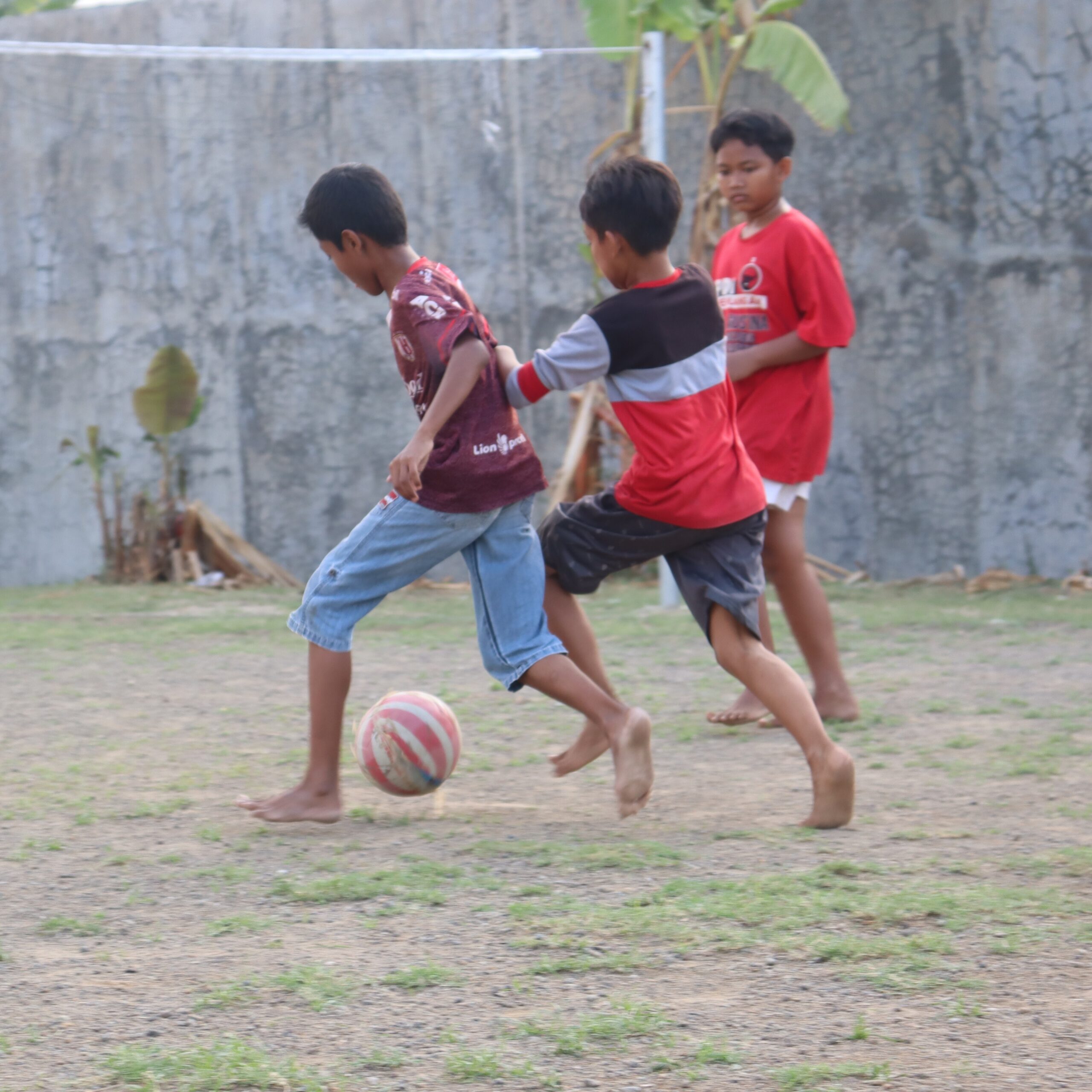 Young Filipino footballers training on a rural barangay pitch
