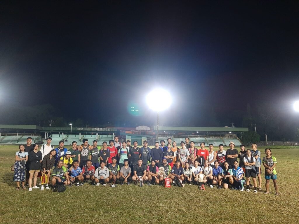 Nuviz Team football players, both men and women, posing together on the field after a match.