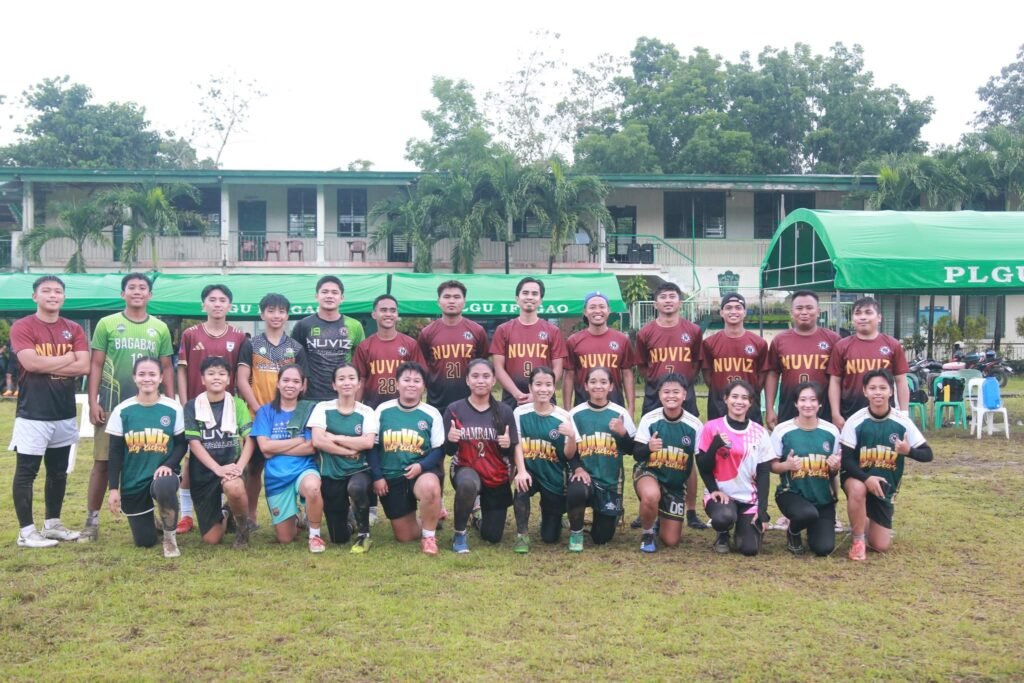 Nuviz Team football players, both men and women, posing together on the field after a match, showing unity and sportsmanship.