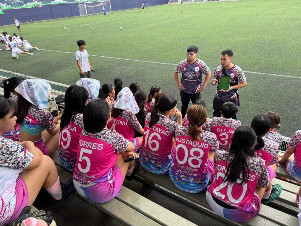 TSL United Football Club coaches giving tactical instructions to young players at McKinley Stadium in Taguig