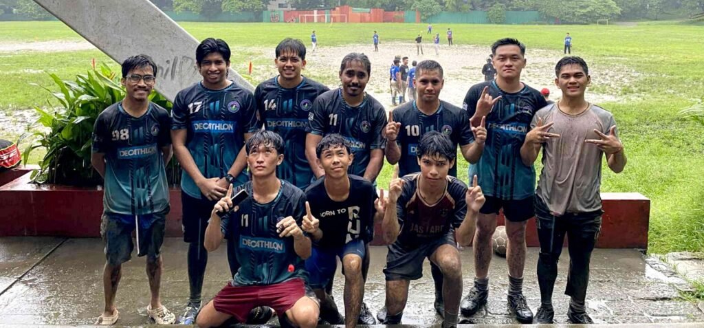 Fairview Amigos FC players posing after training in the rain, showing teamwork and passion for football