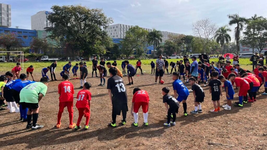 Young football players from Fairview Amigos FC warming up together during weekend training in Quezon City