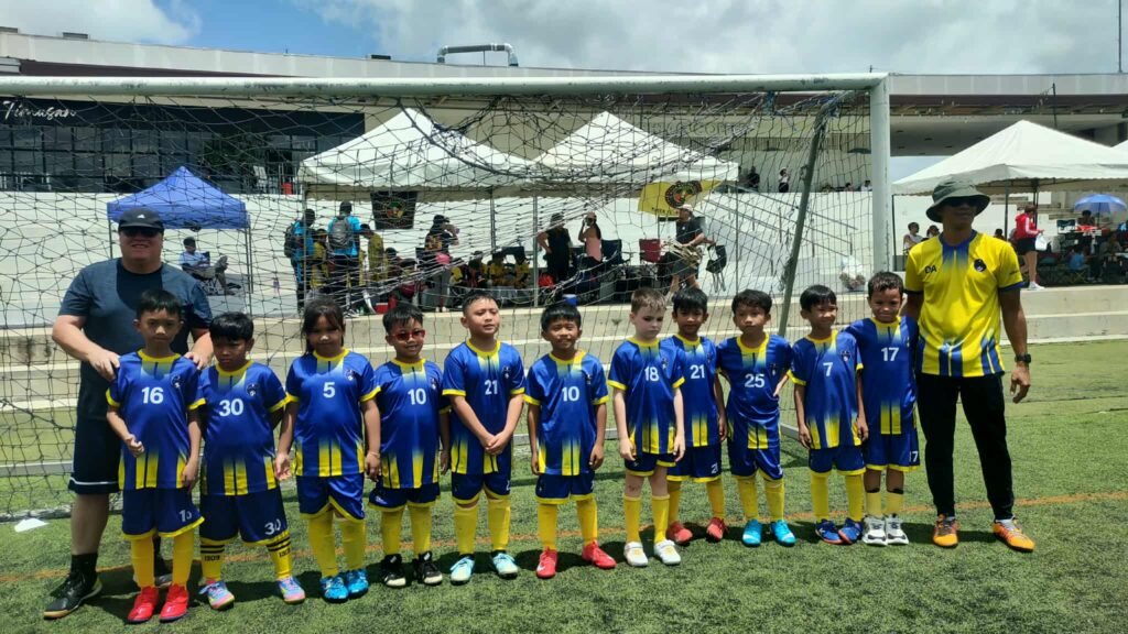 Lungsod Calapan FC youth football players posing with their coach after a match in Calapan City, promoting grassroots football and youth development.