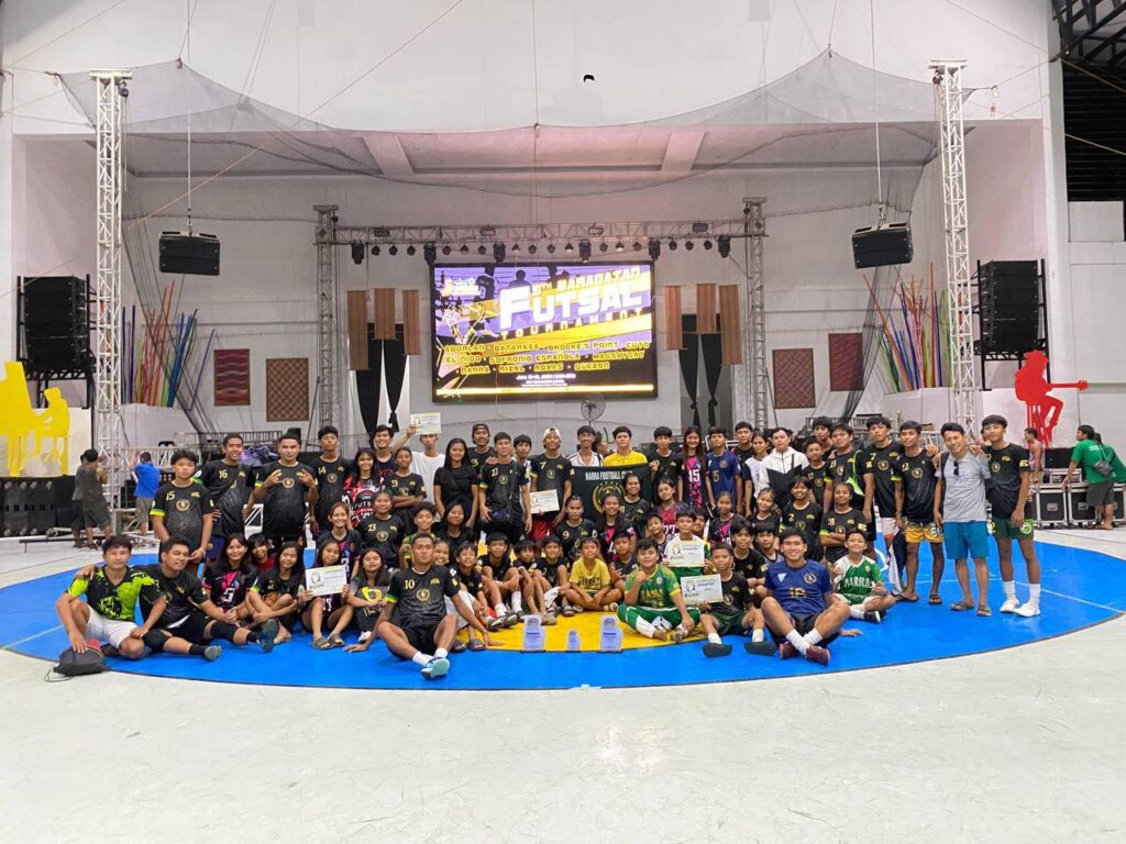 Narra Football Club players and coaches celebrating their Baragatan Festival Futsal Grand Slam championship in Palawan