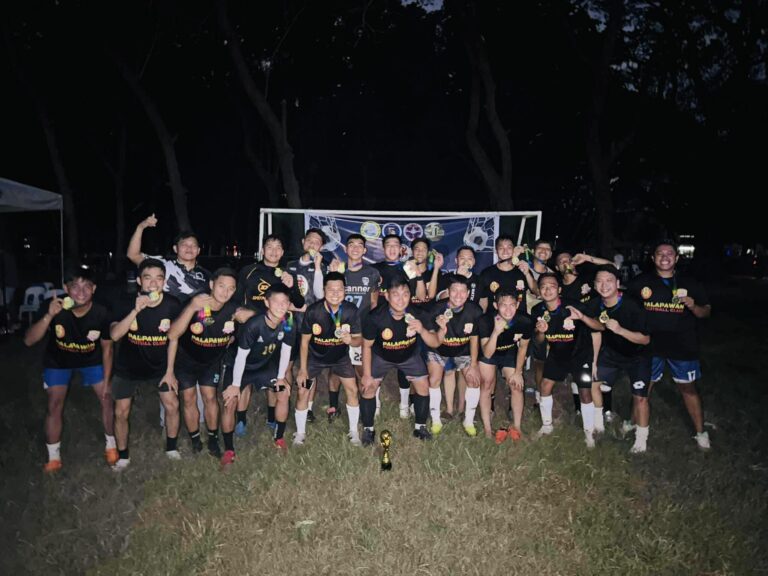 Palapa 1ne Football Club players celebrating a tournament win with medals and trophy at night