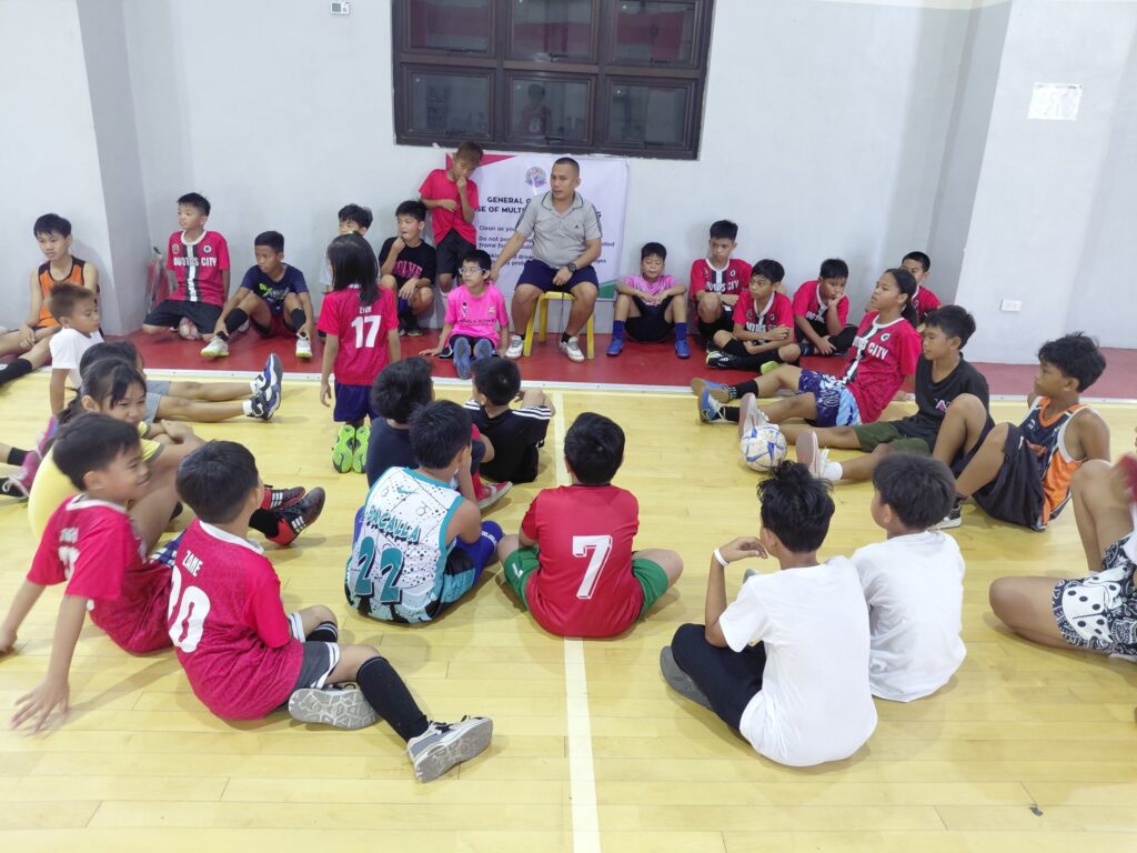Young Lobos Youth Club football players during an indoor training session with their coach in Navotas City, Philippines