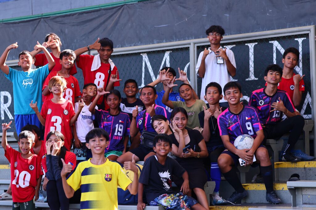 Lobos Youth Club youth football players, coaches, and supporters at a community football venue in Navotas City, Philippines