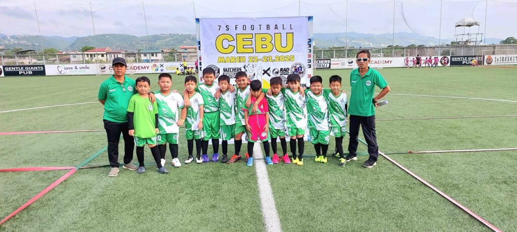 Green Dragons Football Club youth players and coaches standing on the field at the 7s Football Cebu Tournament 2025 in Cebu, wearing green uniforms.