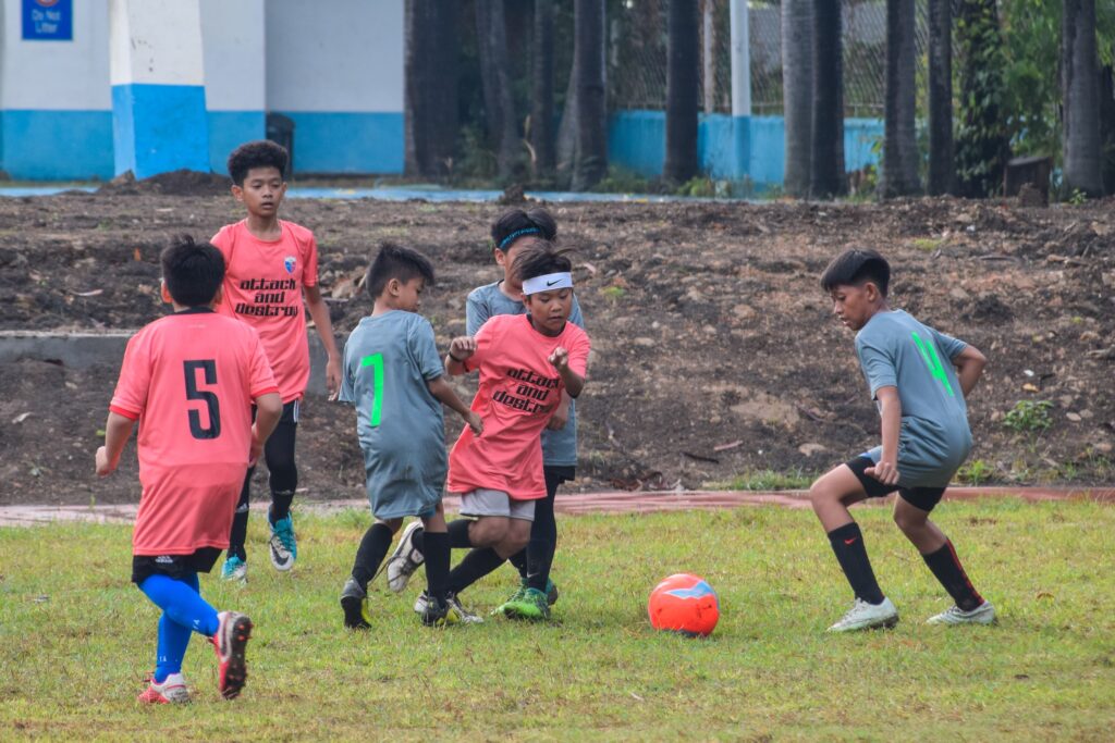 Villamor Football Club where Young boys playing football on a grassy field, competing for the ball during a training match in Villamor.