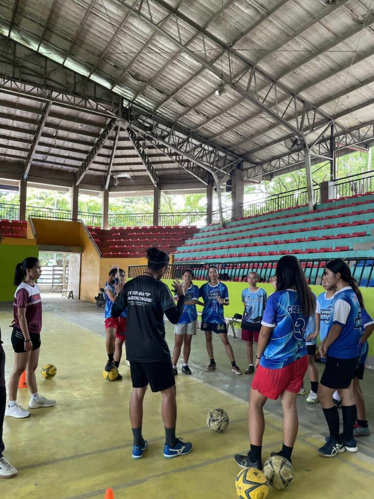 Football players listen to coaching instructions during a training session at Island Grafika Football Academy in Island Garden City of Samal.
