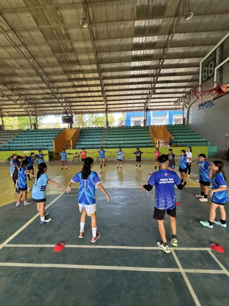 Young football players participate in a group warm-up exercise during an Island Grafika Football Academy training session in Island Garden City of Samal.