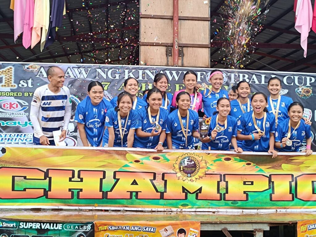 Magis Football Club women's team celebrates their championship victory during a regional football tournament in Mindanao.